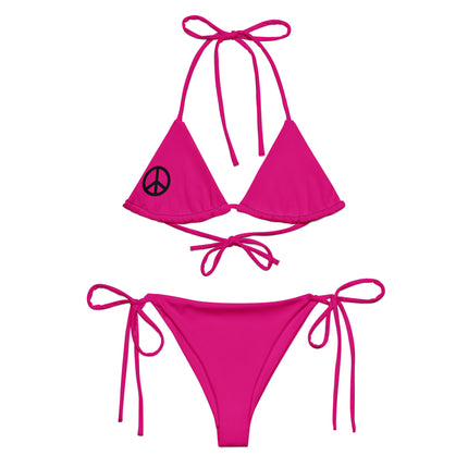 A pink string bikini set with a peace sign on the top and red bow ties at the bottom, displayed on a white background.