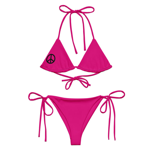A pink string bikini set with a peace sign on the top and red bow ties at the bottom, displayed on a white background.